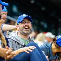 Photo of man laughing in the stands of Comerica Park